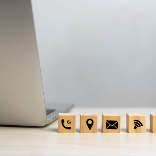 wood cube icon website page contact us or e-mail call phone, address, marketing concept on desk.