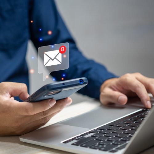 businessman holding hand touchscreen smartphone and checking email icon online or sending mail to partner and customer on web with virtual interface technology concept.